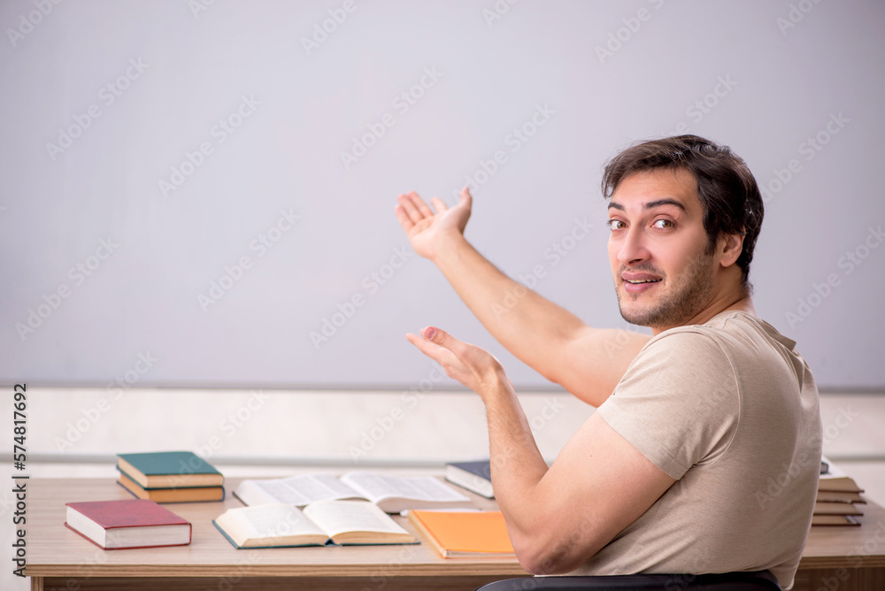 Young male student sitting in the classroom Young male student sitting in the classroom