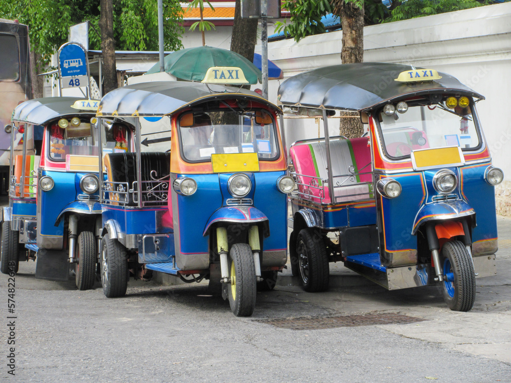 Three tuctucs on a Bangkok street, Thailand