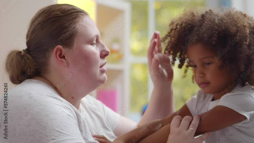 Caucasian woman babysitter try to calm down naughty African-American girl. Realtime Caucasian woman babysitter try to calm down naughty African-American girl. Realtime