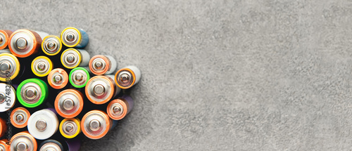 Alkaline batteries on grunge background with space for text