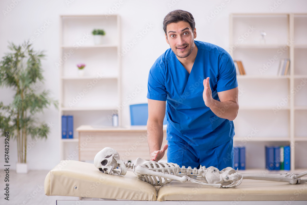 Young male doctor and skeleton patient at the hospital Young male doctor and skeleton patient at the hospital