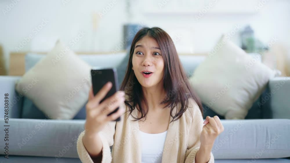 Happy young asian woman relax on comfortable couch at home texting messaging on smartphone, smiling girl use cellphone, chatting online message, shopping online from home Happy young asian woman relax on comfortable couch at home texting messaging on smartphone, smiling girl use cellphone, chatting online message, shopping online from home