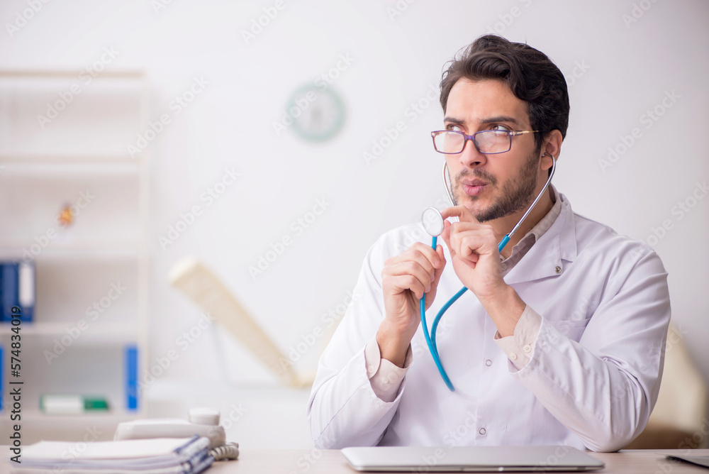 Fototapeta premium Young male doctor working in the clinic