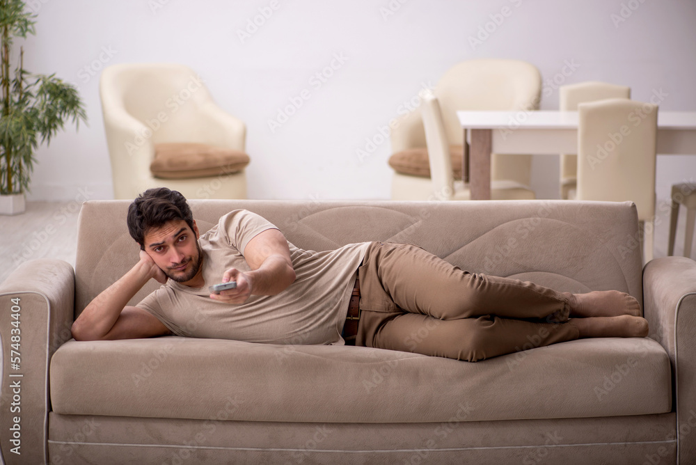 Young man watching tv at home Young man watching tv at home