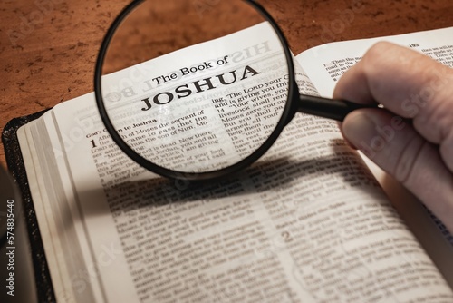 title page book of Joshua close up using magnifying glass in the bible or Torah for faith, christian, hebrew, israelite, history, religion, christianity, Old Testament