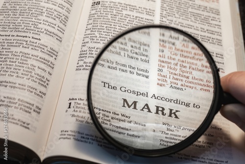 Valokuva title page book of Mark close up using magnifying glass in the bible for faith,