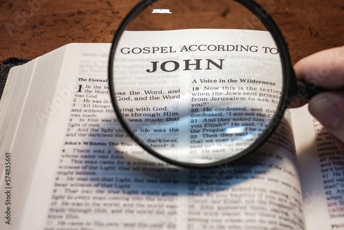 title page book of John close up using magnifying glass in the bible for faith, christian, hebrew, israelite, history, religion, christianity, new testament