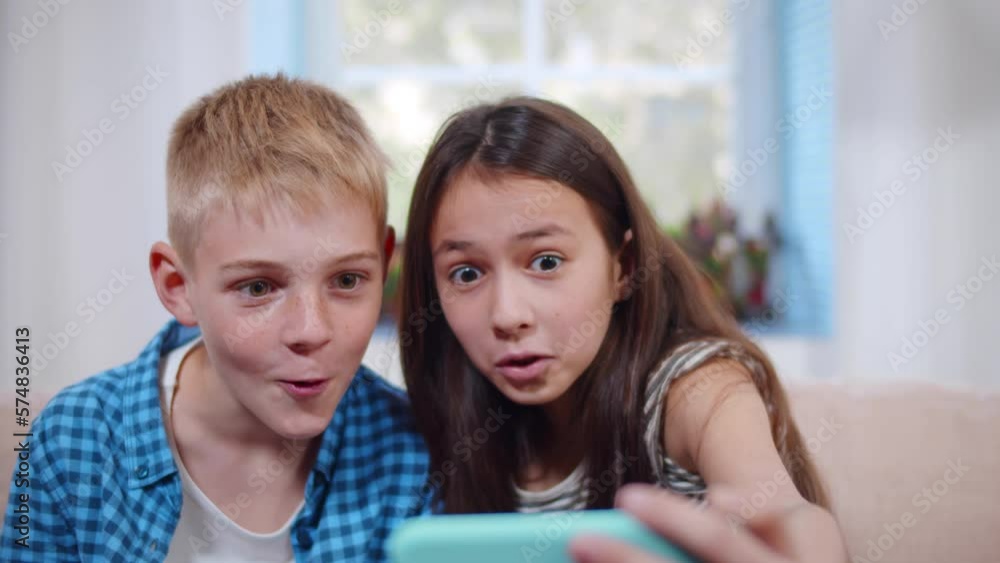 Preteen brother and sister take selfie on smartphone. Realtime Preteen brother and sister take selfie on smartphone. Realtime
