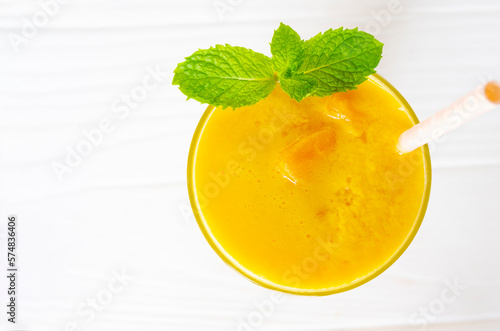 Mango smoothies yellow colorful fruit juice milkshake blend beverage healthy high protein the taste yummy In glass,drink to lose weight drink episode morning on white gray background.