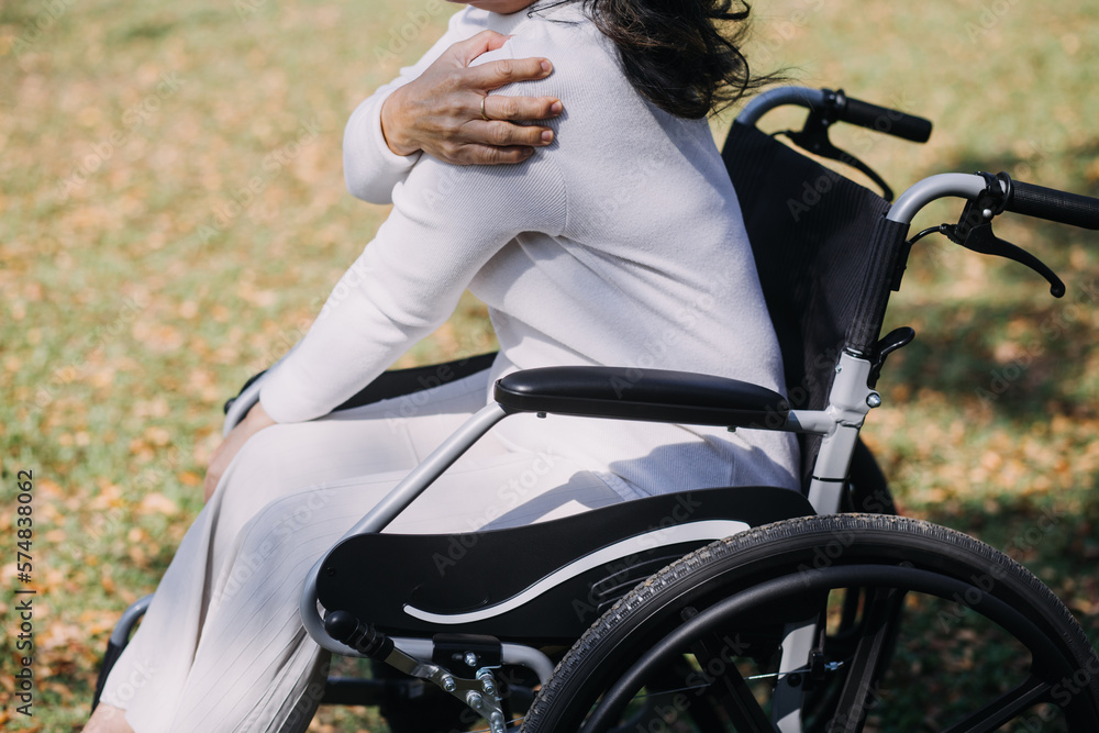 Obraz premium Asian young caregiver nurse support senior older male walking outdoors. Specialist girl doctor help and take care of elderly mature man patient doing physical therapy in public park at nursing home.