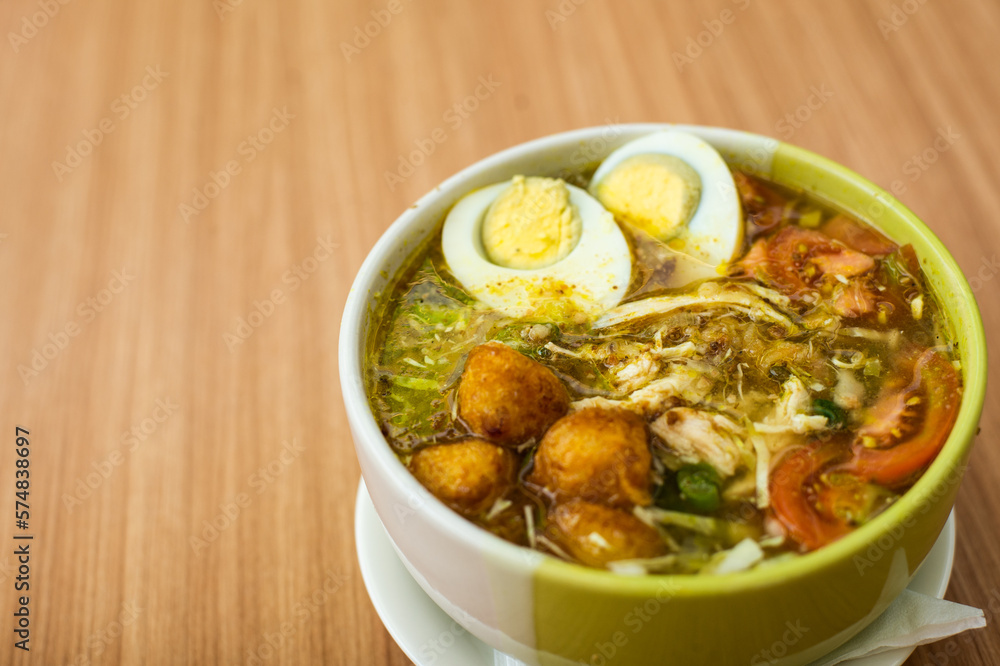 A Plate of Soto Ayam served with rice and condiments A Plate of Soto Ayam served with rice and condiments