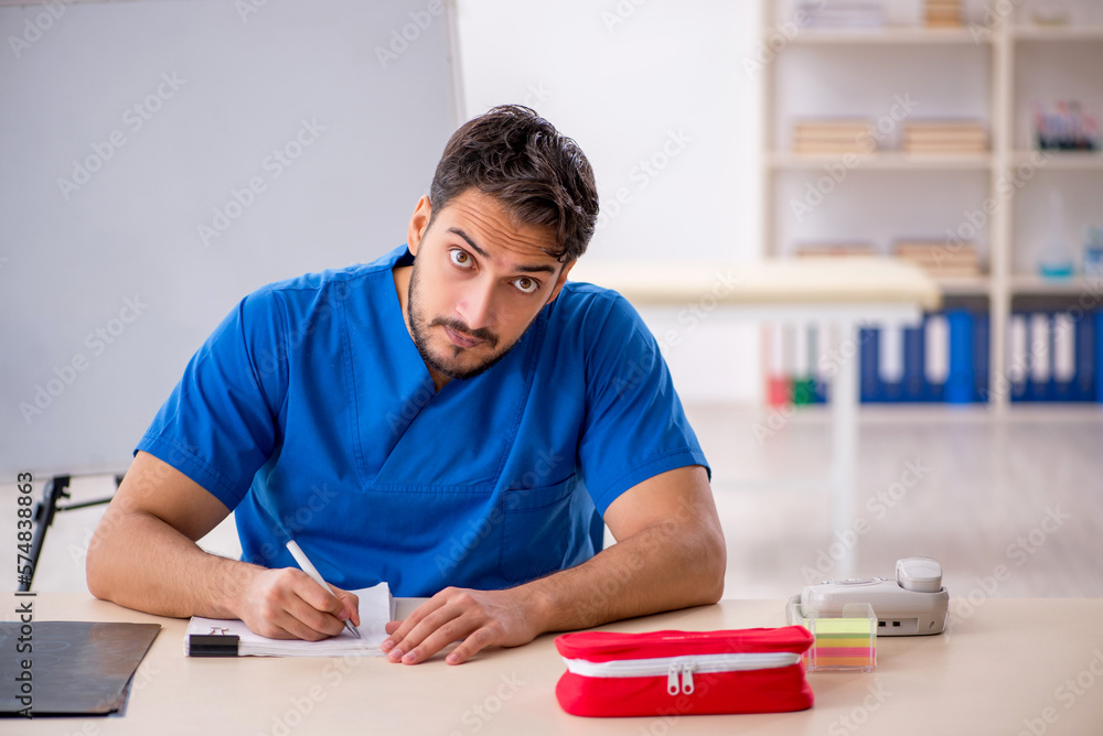Young male doctor working in the clinic Young male doctor working in the clinic
