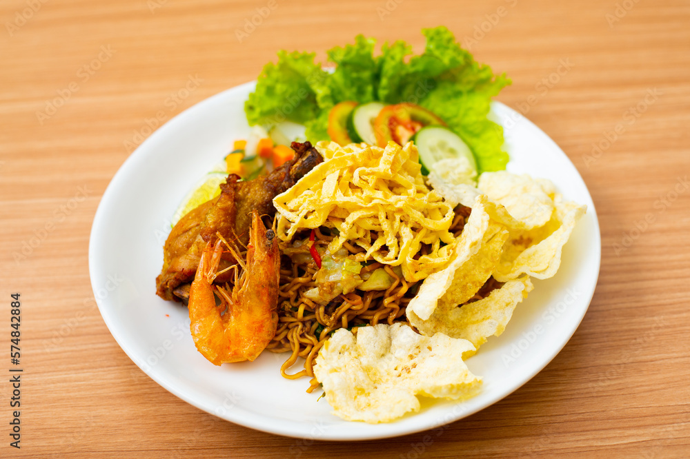 Indonesian fried noodles served with shrimp and chicken Indonesian fried noodles served with shrimp and chicken