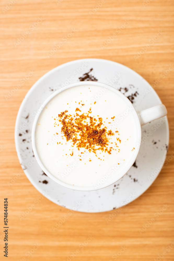 A Glass of cappucino coffee, sprinkled with coffee powder on top of the foam A Glass of cappucino coffee, sprinkled with coffee powder on top of the foam