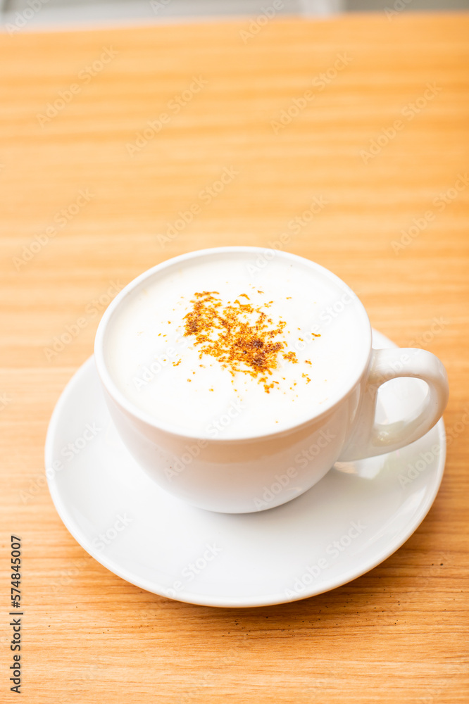 A Glass of cappucino coffee, sprinkled with coffee powder on top of the foam A Glass of cappucino coffee, sprinkled with coffee powder on top of the foam