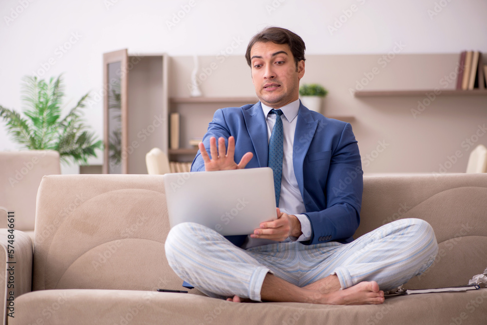 Young male employee working from home during pandemic