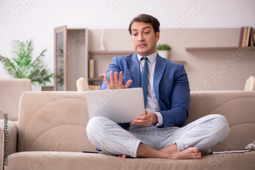 Young male employee working from home during pandemic
