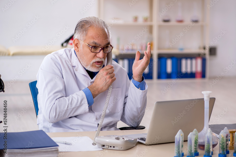 Old male chemist in drugs synthesis concept Old male chemist in drugs synthesis concept