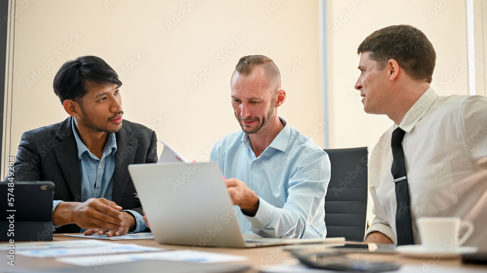 Team of business financial analysts discussing project, sharing their business ideas Team of business financial analysts discussing project, sharing their business ideas