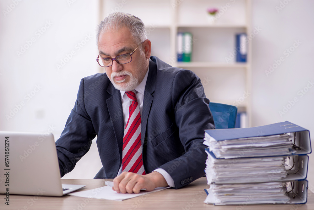 Old male employee and too much work in the office Old male employee and too much work in the office