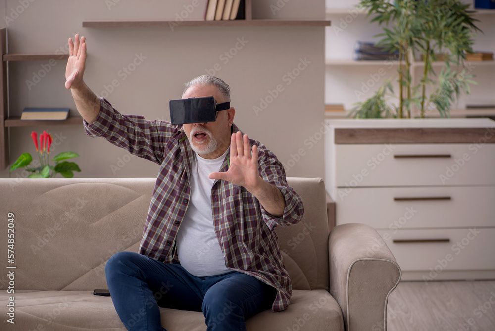 Old man wearing virtual glasses at home Old man wearing virtual glasses at home