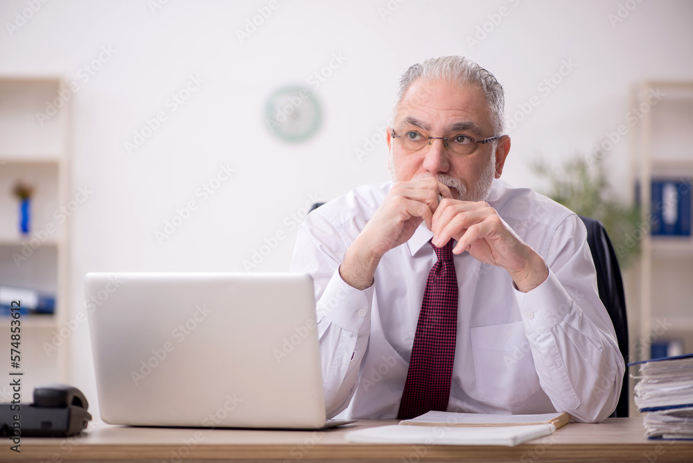 Old male employee and too much work in the office Old male employee and too much work in the office