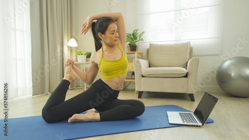 Portrait of Asian woman in yoga class club doing exercise, at home or house. Indoor online sport and recreation. People lifestyle activity. Self-isolate. Quarantine in room