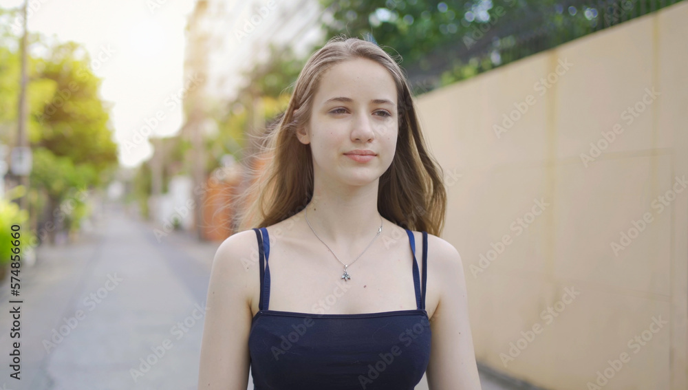 Portrait of Caucasian woman girl in yoga class club doing exercise, runing or jogging at urban city town street road. Outdoor sport and recreation. People lifestyle activity with nature trees view.