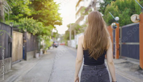 Portrait of Caucasian woman girl in yoga class club doing exercise, runing or jogging at urban city town street road. Outdoor sport and recreation. People lifestyle activity with nature trees view.