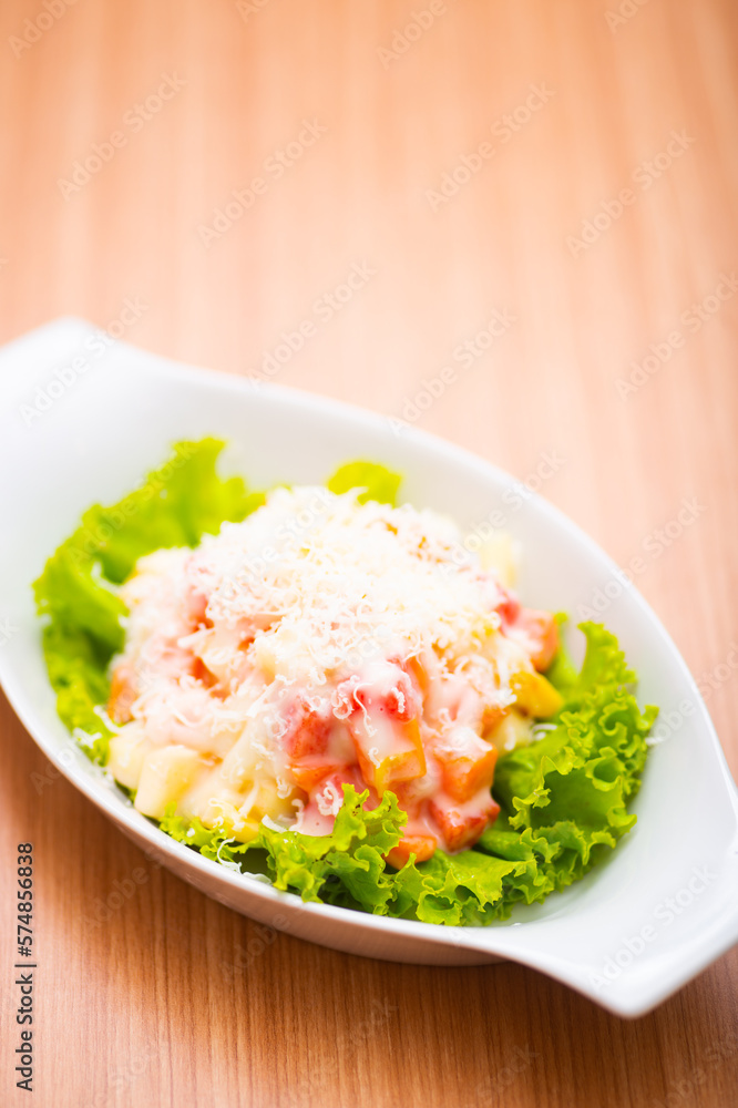 A Serving of healthy salad topped with mayonaise A Serving of healthy salad topped with mayonaise
