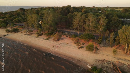 Aerial Shot Of People Playing Beach Volley On Fray Bentos Coast, Uruguay photo