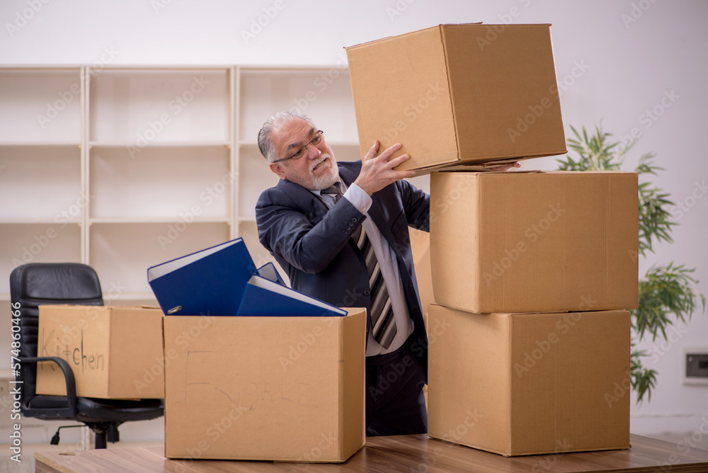 Old male employee in office relocation concept Old male employee in office relocation concept
