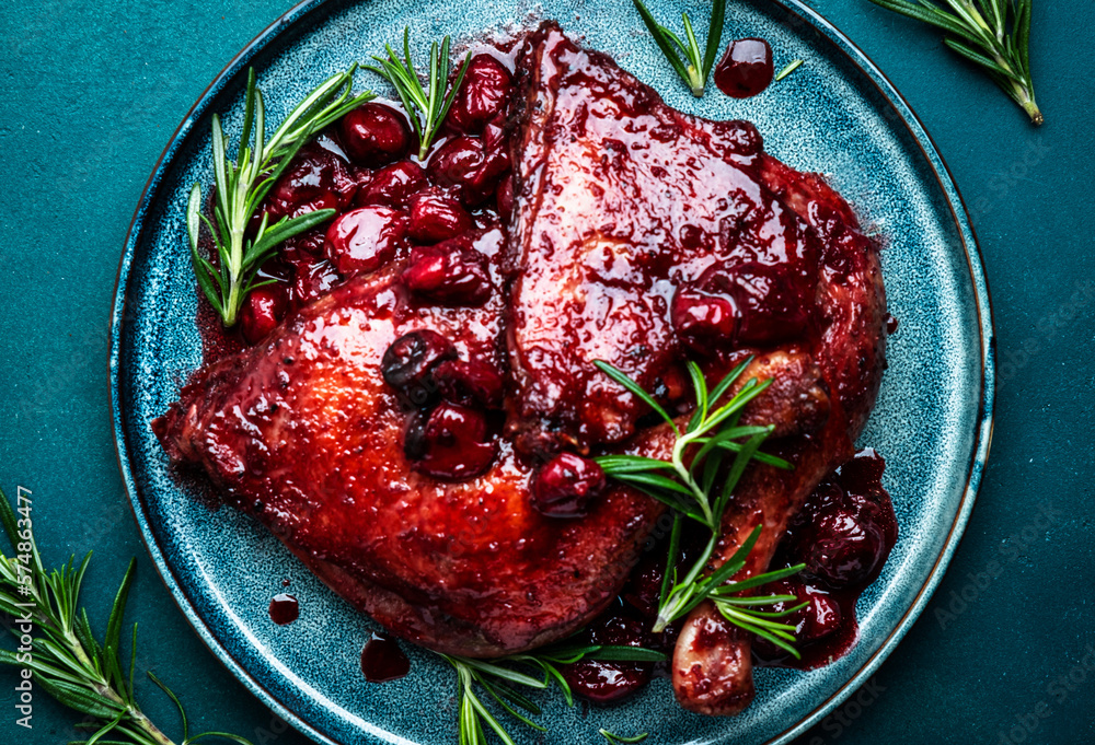 Baked duck legs in cherry and red wine sauce with rosemary. Delicacy