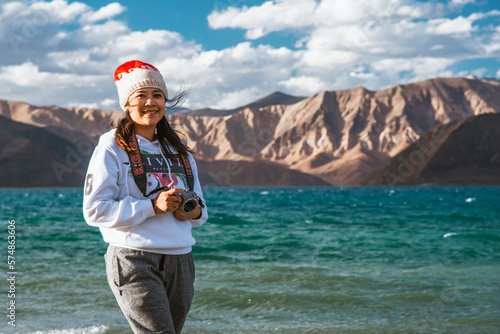 Happy Girl carry a camera at Pangong lake, Leh Ladakh, India