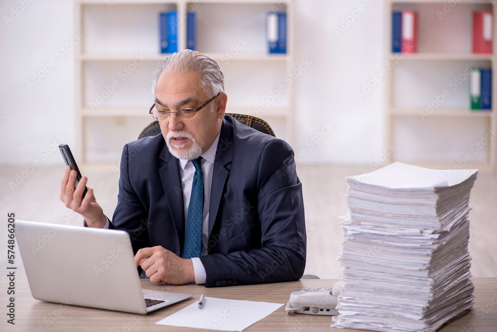Old male employee and too much work in the office Old male employee and too much work in the office