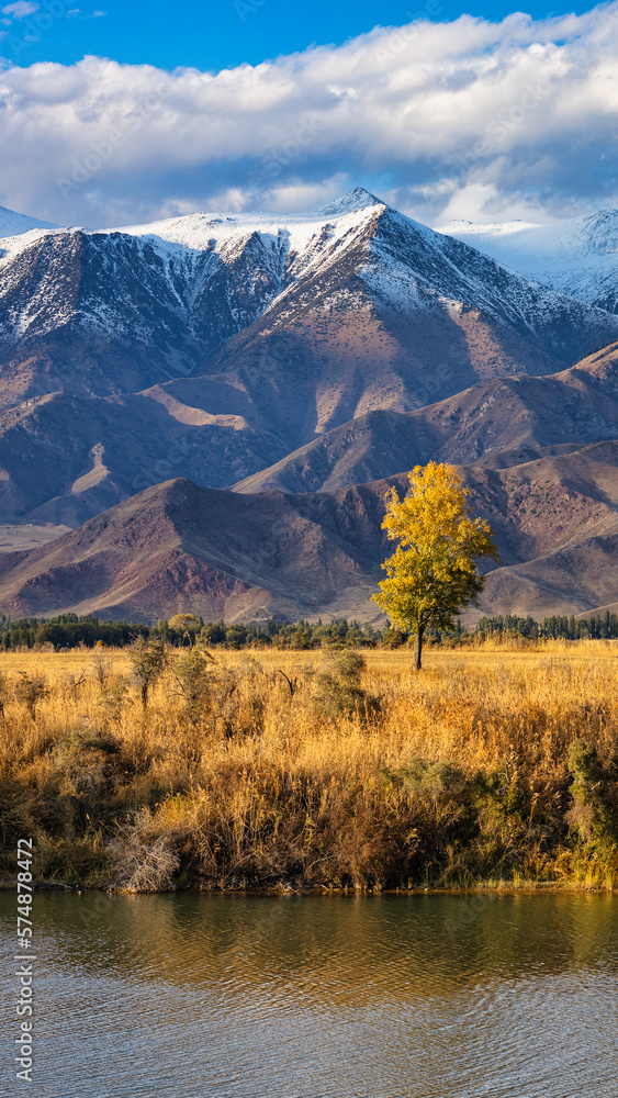Amazing autumn landscape of Kyrgyzstan on an autumn evening near Issyk-Kul lake with a mountain view