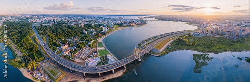 Panoramic view of the Kazan city at sunset in summer. The Kazanka River, the Millenium Bridge and the reflection of water. Capital of the Republic of Tatarstan. Megalopolises of Russia. Big resolution