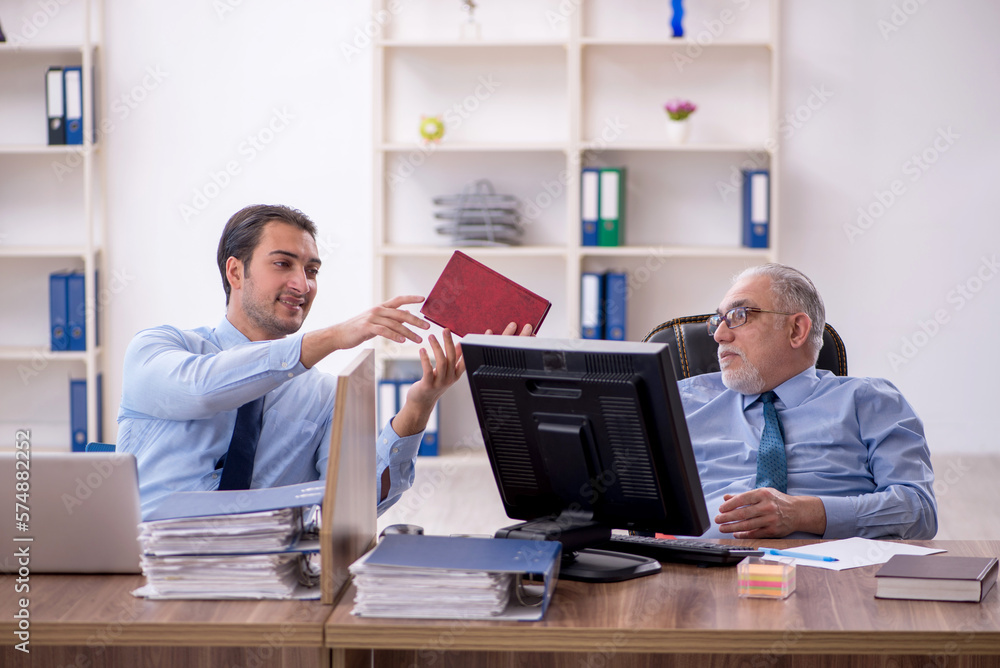 Two male colleagues working in the office Two male colleagues working in the office
