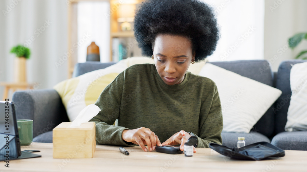 Happy African American woman using a glucose monitoring device at home. Smiling black female checking her sugar level with a rapid test result kit, daily routine of diabetic care in a living room Happy African American woman using a glucose monitoring device at home. Smiling black female checking her sugar level with a rapid test result kit, daily routine of diabetic care in a living room