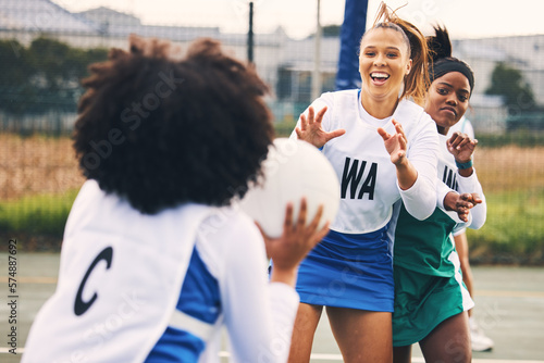 Netball, sport and women in a match or game being competitive in a competition on a court as teammates. Training, fitness and female athletes happy for high school sports and exercise as a team