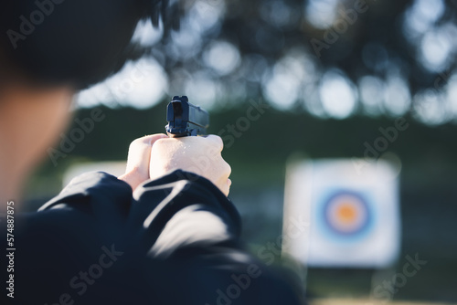 Firearm, target and person training outdoor at shooting range for game exercise or sports challenge closeup. Man hands with gun, circle and aim for practice, police academy or field practice mission