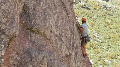 A Middle-Aged Man rock climbing on a wall. Comechingones mountains. Cordoba, Argentina. photo