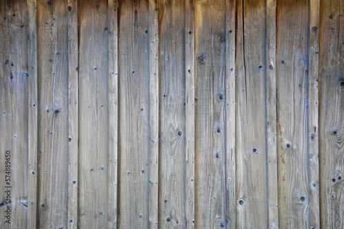 brown natural wooden background planks wall of vertical wood boards on horizontal facade