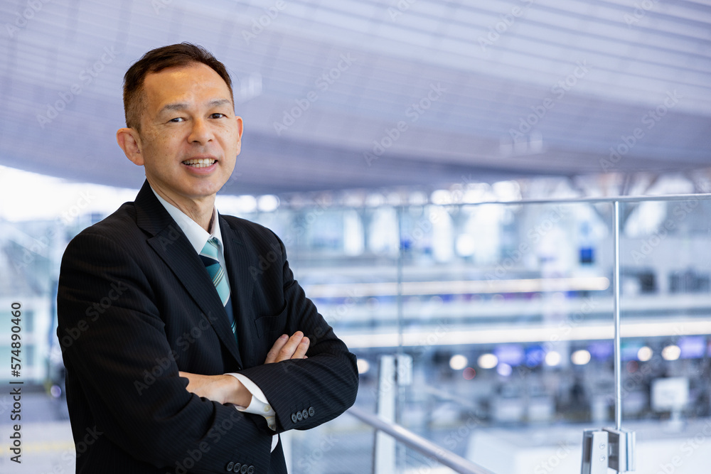 Asian middle-class businessman heading for an overseas business trip in the airport lobby. Asian middle-class businessman heading for an overseas business trip in the airport lobby.