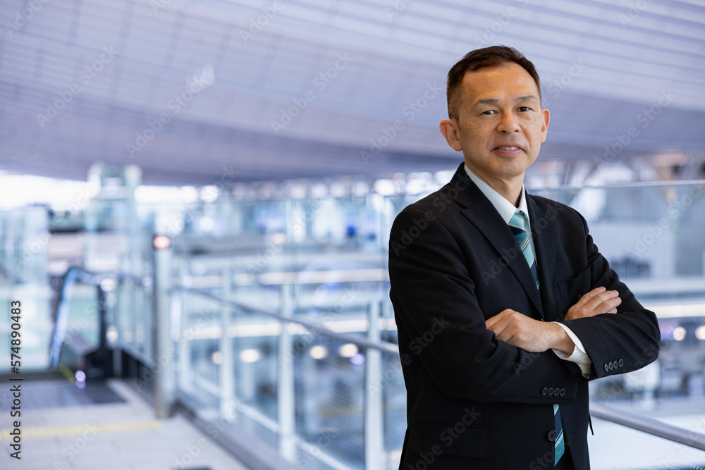 Asian middle-class businessman heading for an overseas business trip in the airport lobby. Asian middle-class businessman heading for an overseas business trip in the airport lobby.