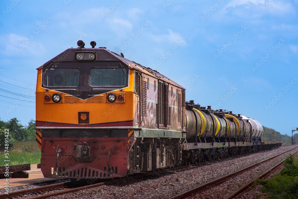 Obraz premium Tanker-freight train by diesel locomotive on the railway.