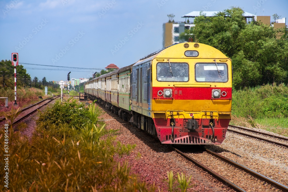 Naklejka premium Passenger train by diesel locomotive on the railway.