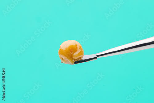 Live Rosin on dab tool with bright teal background