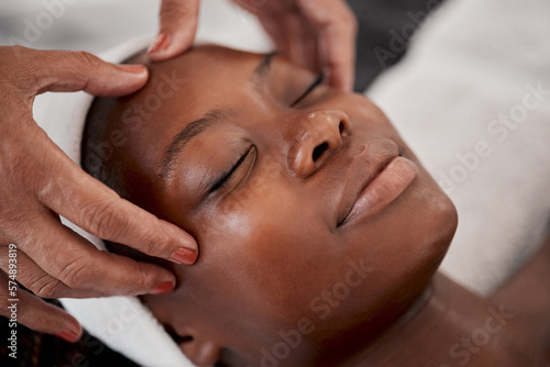Black woman, relax face and luxury spa massage of a young female ready for facial. Skincare, beauty and wellness clinic with client feeling calm and zen from cosmetic chemical peel treatment