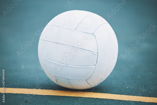 Netball on the floor on a sport court for a game, training or exercise outdoor on a field. Sports, fitness and white ball on the ground for a match, workout or practice competition by a outside arena